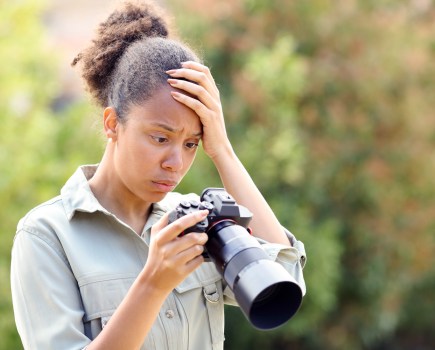 Worried photographer is unhappy with image on the camera. Pheelings Media, Getty Images