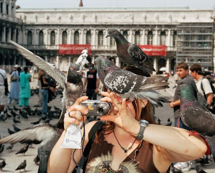 Venice, Italy, 2005 © Martin Parr / Magnum Photos woman holding up compact camera with pigeons on shoulder