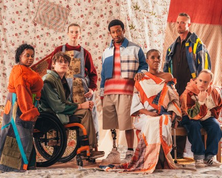 portrait of a group of people posing with mismatched clohing